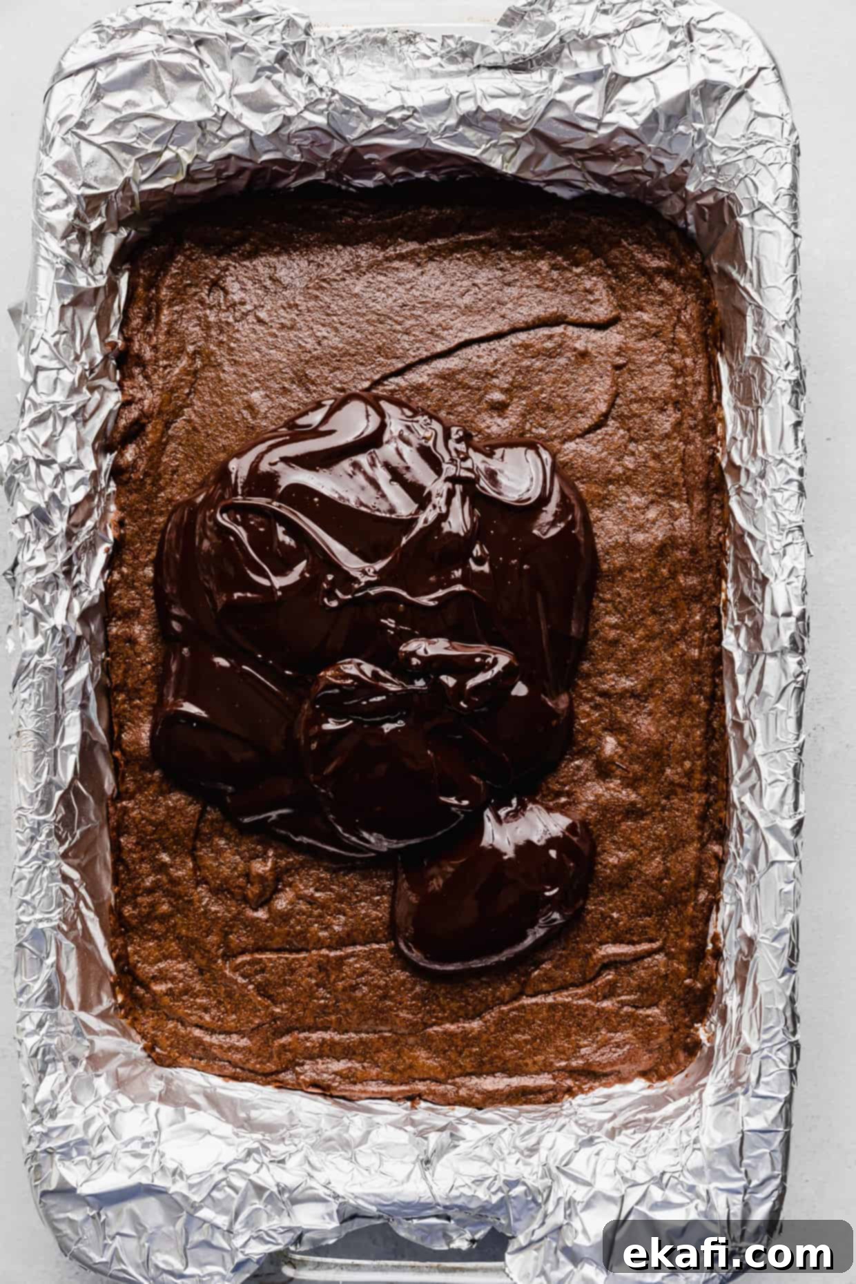 Stardust Brownies 14 A generous pile of dark, glossy chocolate ganache spread over a pan of cooled Cosmic Brownies.