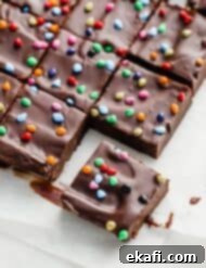 Stardust Brownies 18 Squares of rainbow chip topped cosmic brownies on a white parchment paper.