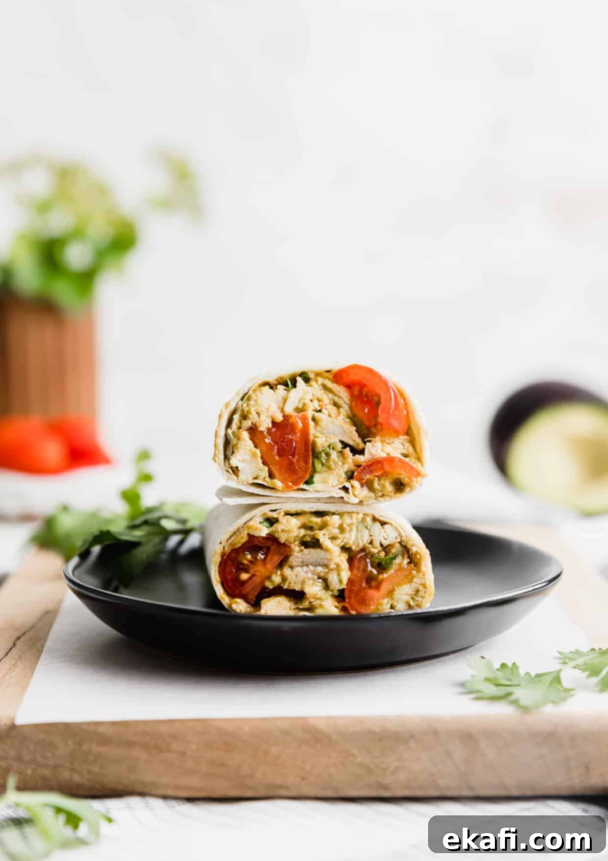Creamy Avocado Chicken Wraps 9 Multiple Avocado Chicken Wraps arranged aesthetically on a black plate, ready to serve.