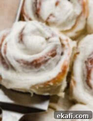 Delicious Homemade Cinnamon Rolls 14 A close up of a vanilla frosting cinnamon roll.