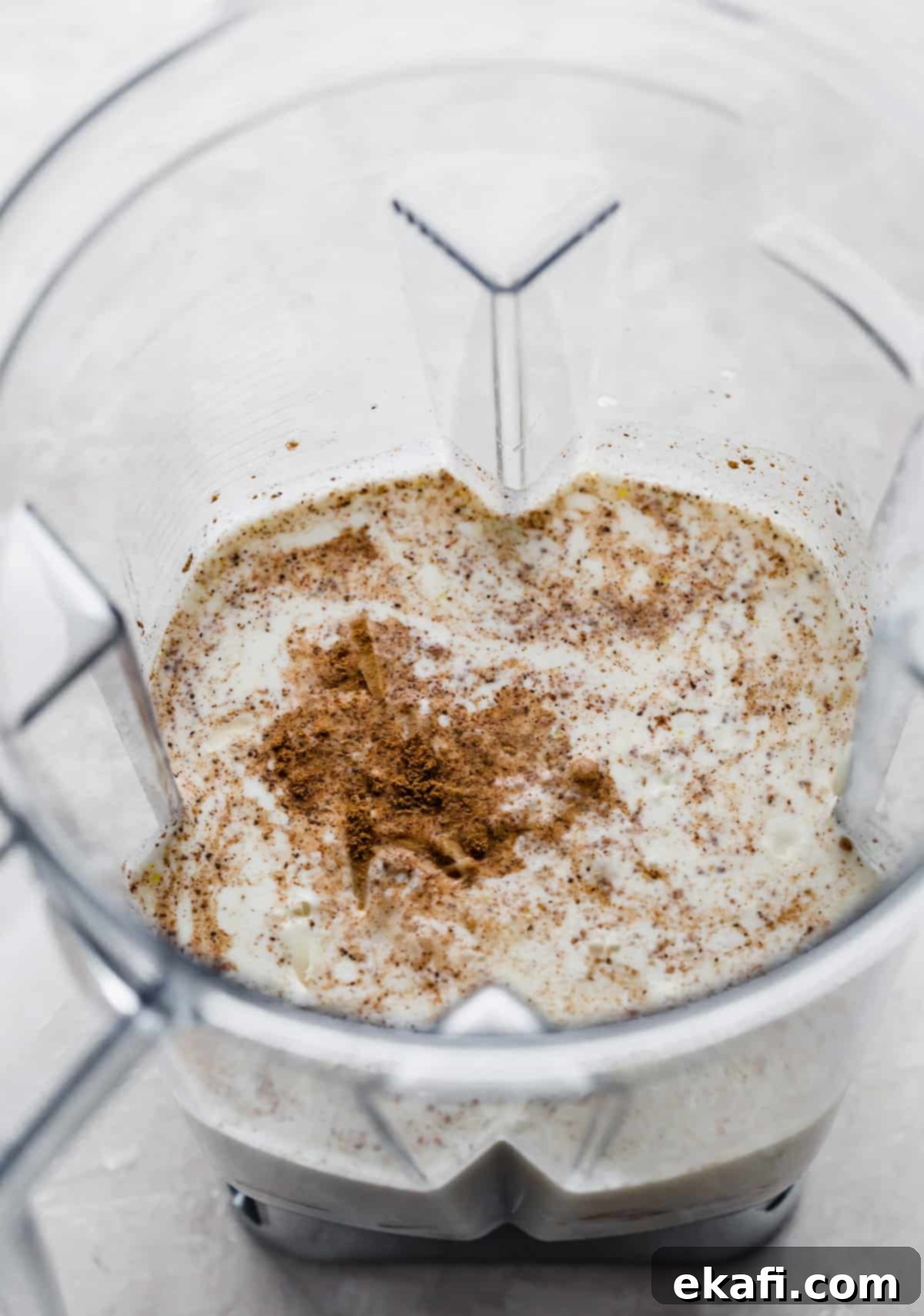 Velvety Butternut Squash Pasta 5 A blender half full of creamy half and half, with a generous sprinkle of ground nutmeg on top, ready to be blended into the butternut squash sauce.