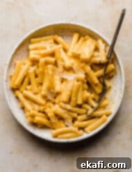 Velvety Butternut Squash Pasta 9 Ziti noodles covered in a creamy orange butternut squash pasta sauce, garnished with fresh parsley.