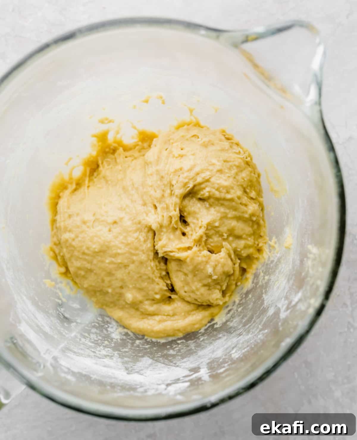 Pillowy Flaky Brioche 6 Smooth, elastic brioche dough in a glass mixing bowl after proper kneading.