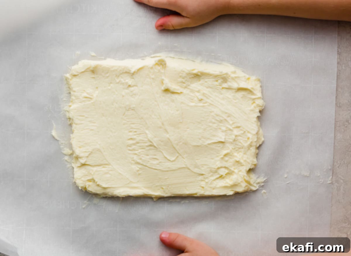 Pillowy Flaky Brioche 7 Perfectly flattened and smoothed butter in a rectangular shape on parchment paper, ready for lamination.