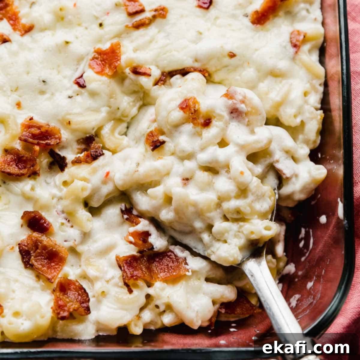Happy Tummies Happy Kids 15 A close-up photo of creamy Pepper Jack Mac and Cheese, generously topped with savory chunks of crispy bacon, highlighting its rich and comforting appeal.