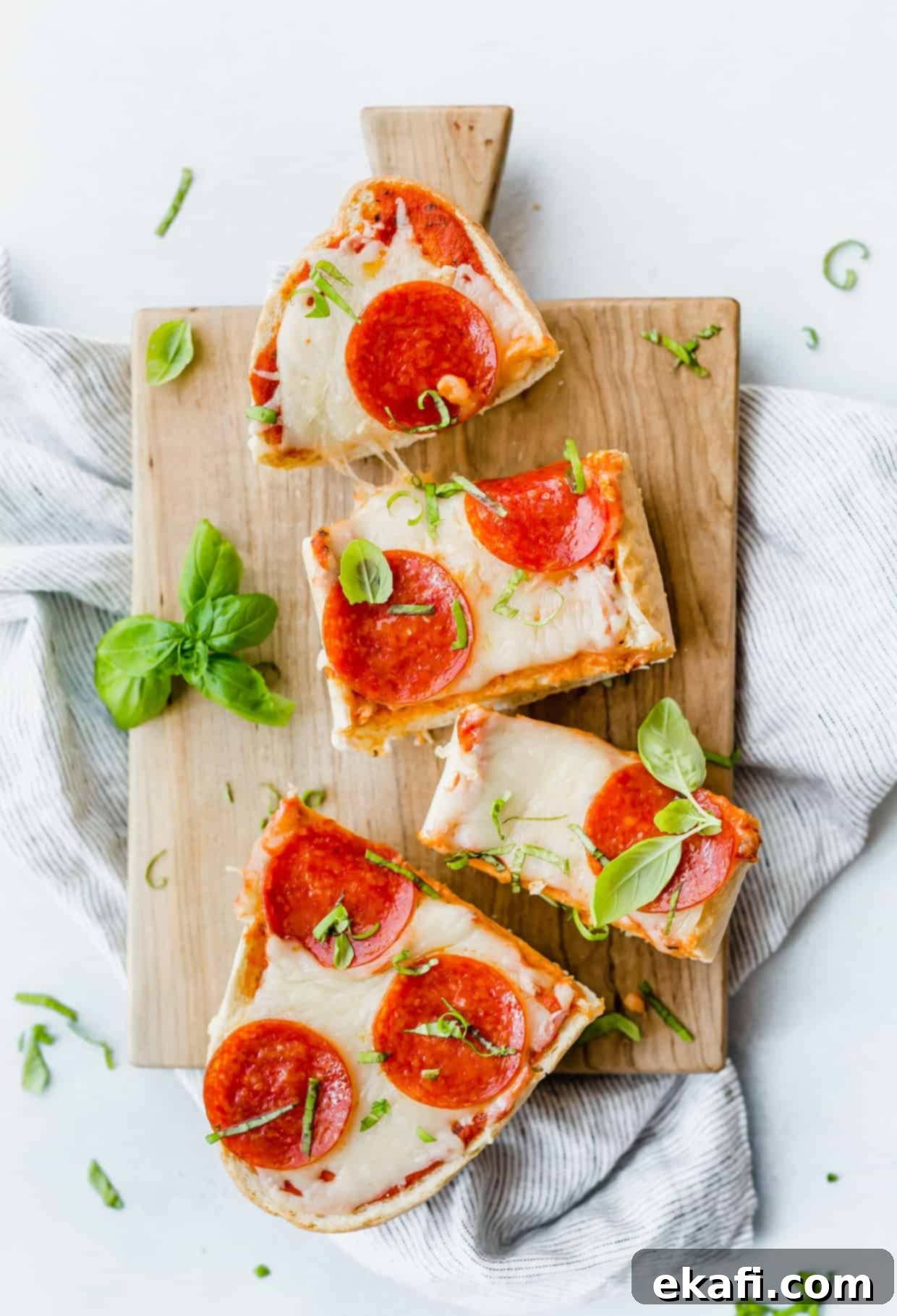 Happy Tummies Happy Kids 5 An inviting overhead view of a golden French Bread Pizza, generously topped with savory pepperoni slices and elegantly garnished with fresh basil, ready to be served.