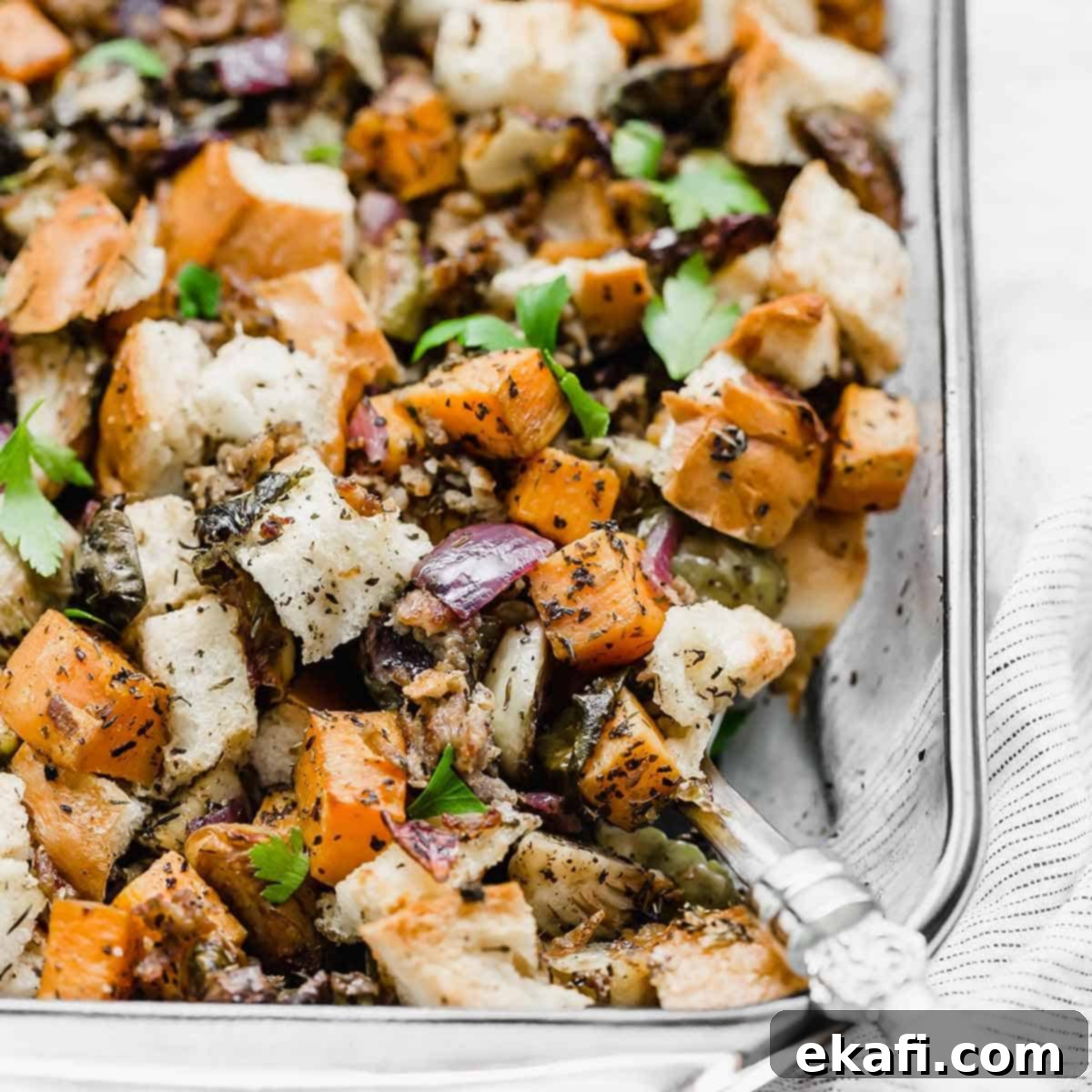Savory Italian Sausage Dressing 6 Vegetable Stuffing in a glass baking dish, featuring purple onion, sweet potato, and Brussels sprouts.