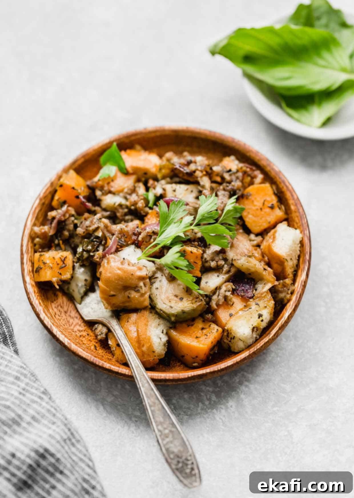 Savory Italian Sausage Dressing 7 A wood plate with Vegetable Stuffing on it.