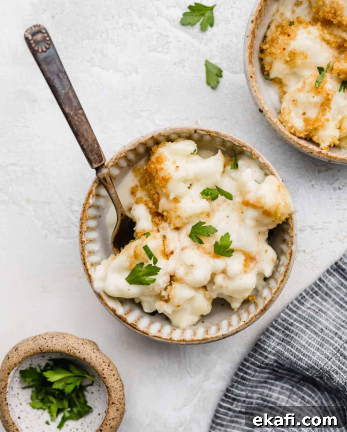 Creamy Baked Cauliflower 2 Parsley garnished Cauliflower Gratin in a bowl.