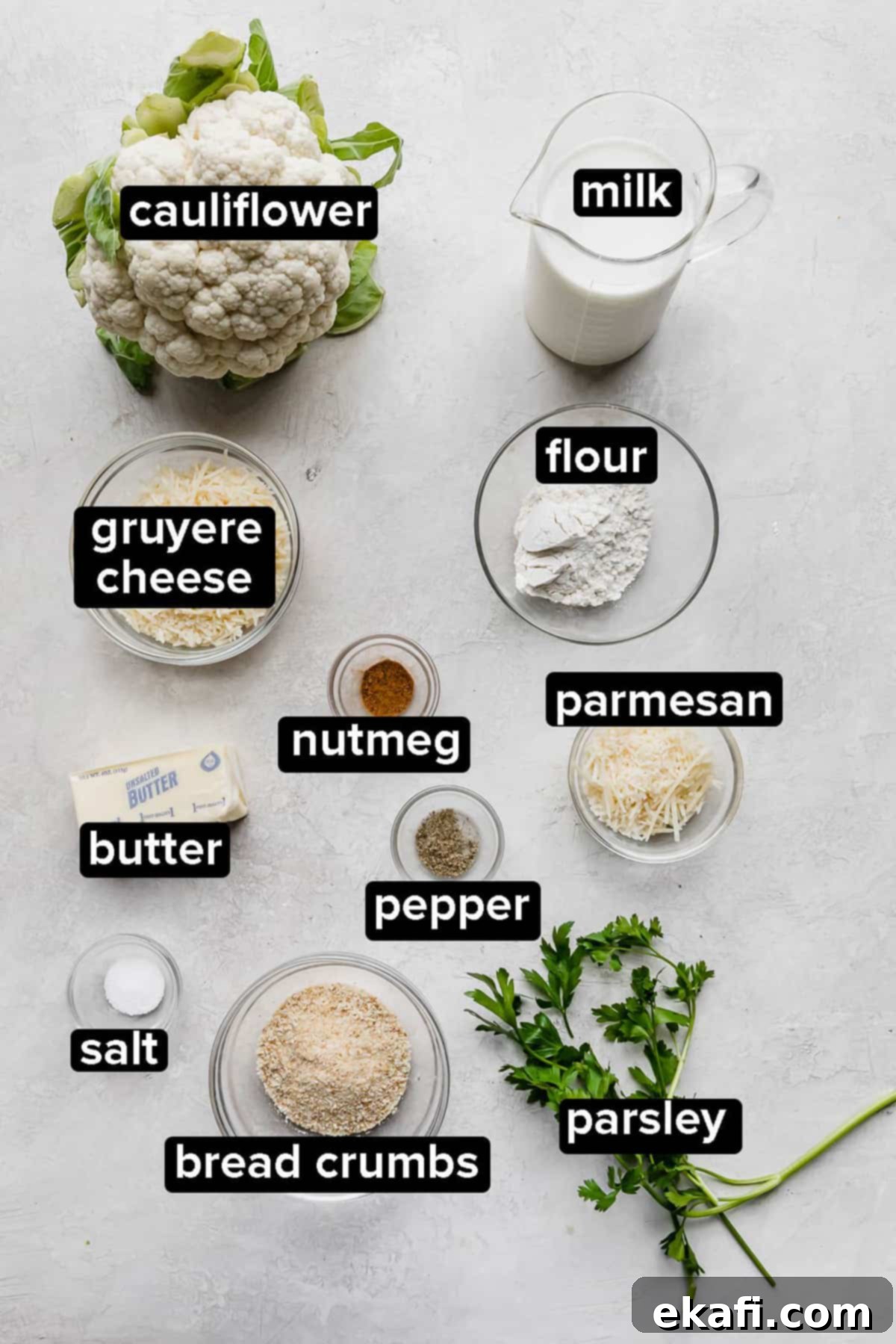 Creamy Baked Cauliflower 3 Cauliflower Gratin ingredients on a gray background.
