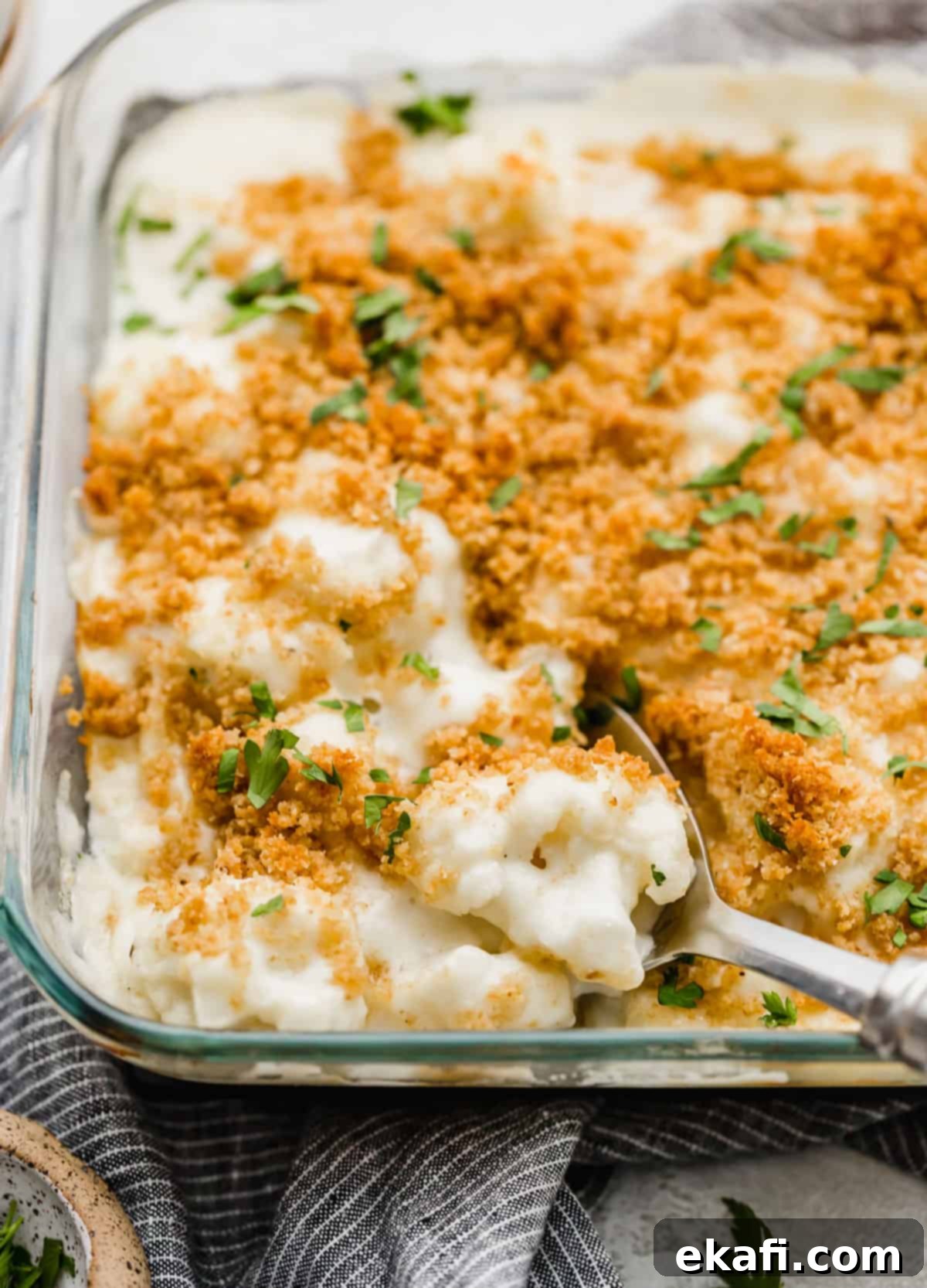 Creamy Baked Cauliflower 8 Cheesy breadcrumb and parsley topped Cauliflower Gratin in a glass square baking dish.