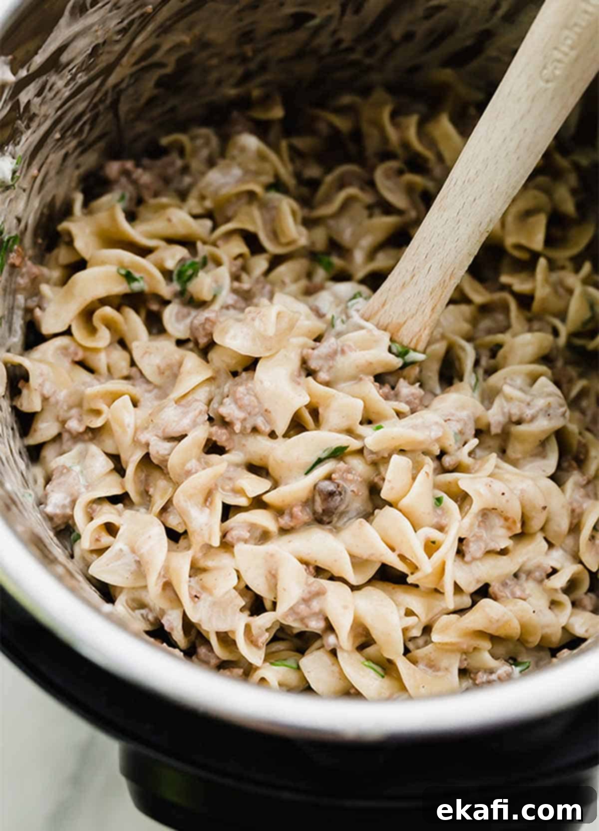 Instant Pot Ground Beef Stroganoff 2 Instant Pot Beef Stroganoff in the bowl of an instant pot, garnished with fresh parsley.