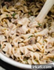 Instant Pot Ground Beef Stroganoff 7 An instant pot filled with creamy ground beef stroganoff, ready to be scooped into bowls.