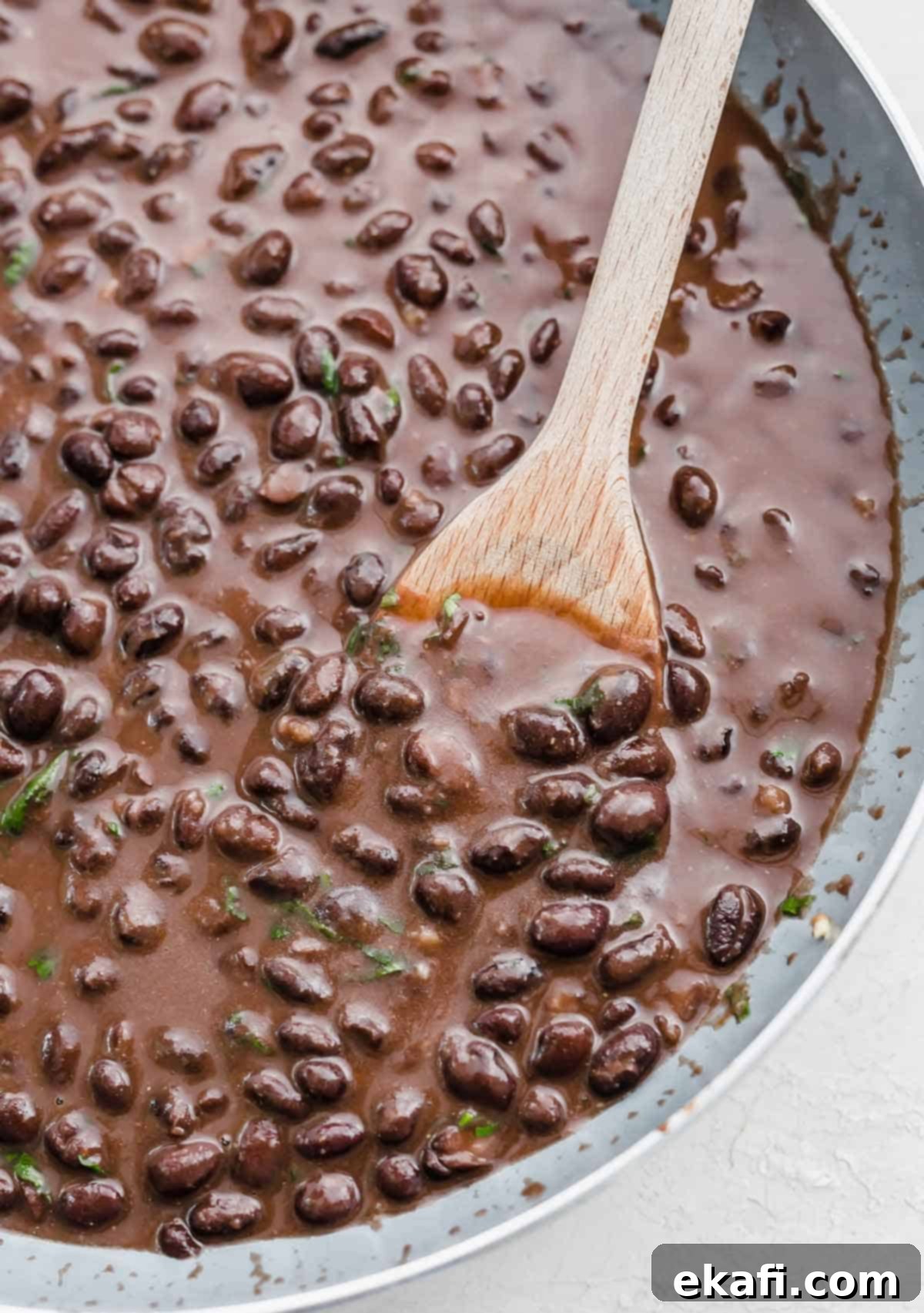Cafe Rio Style Black Beans 2 A gray skillet filled with creamy, seasoned Cafe Rio black beans.