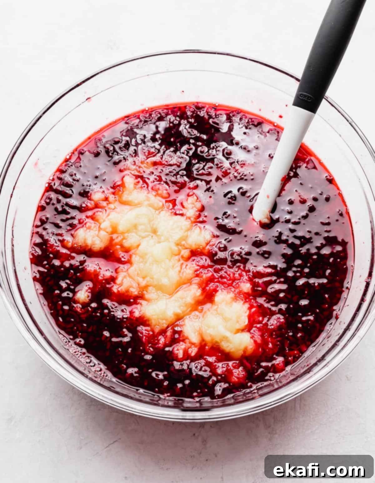 Ruby Pomegranate Delight 6 Crushed pineapple in a dark red liquid Pomegranate Jell-O solution.