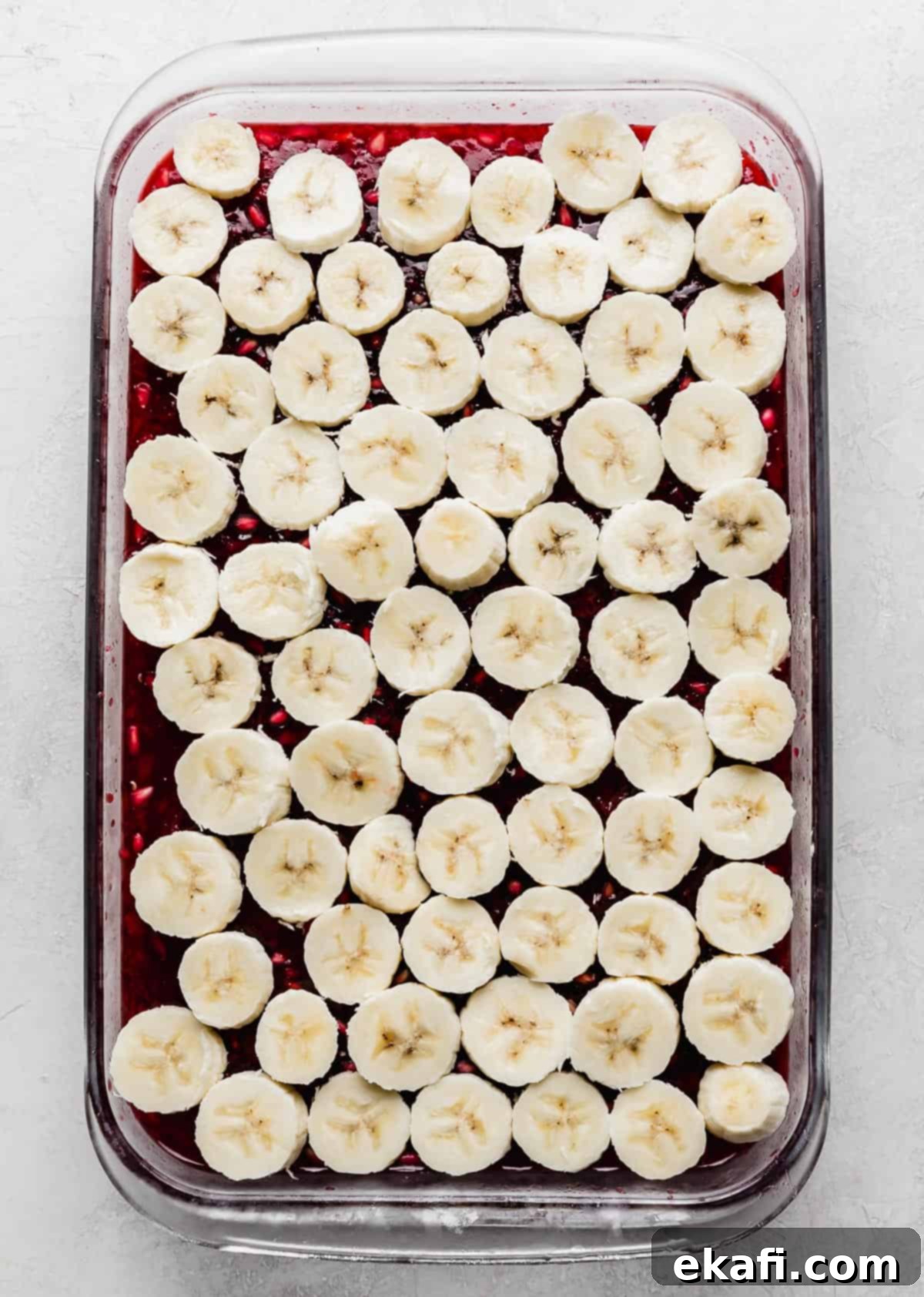 Ruby Pomegranate Delight 9 Pomegranate Jell-O topped with sliced bananas.
