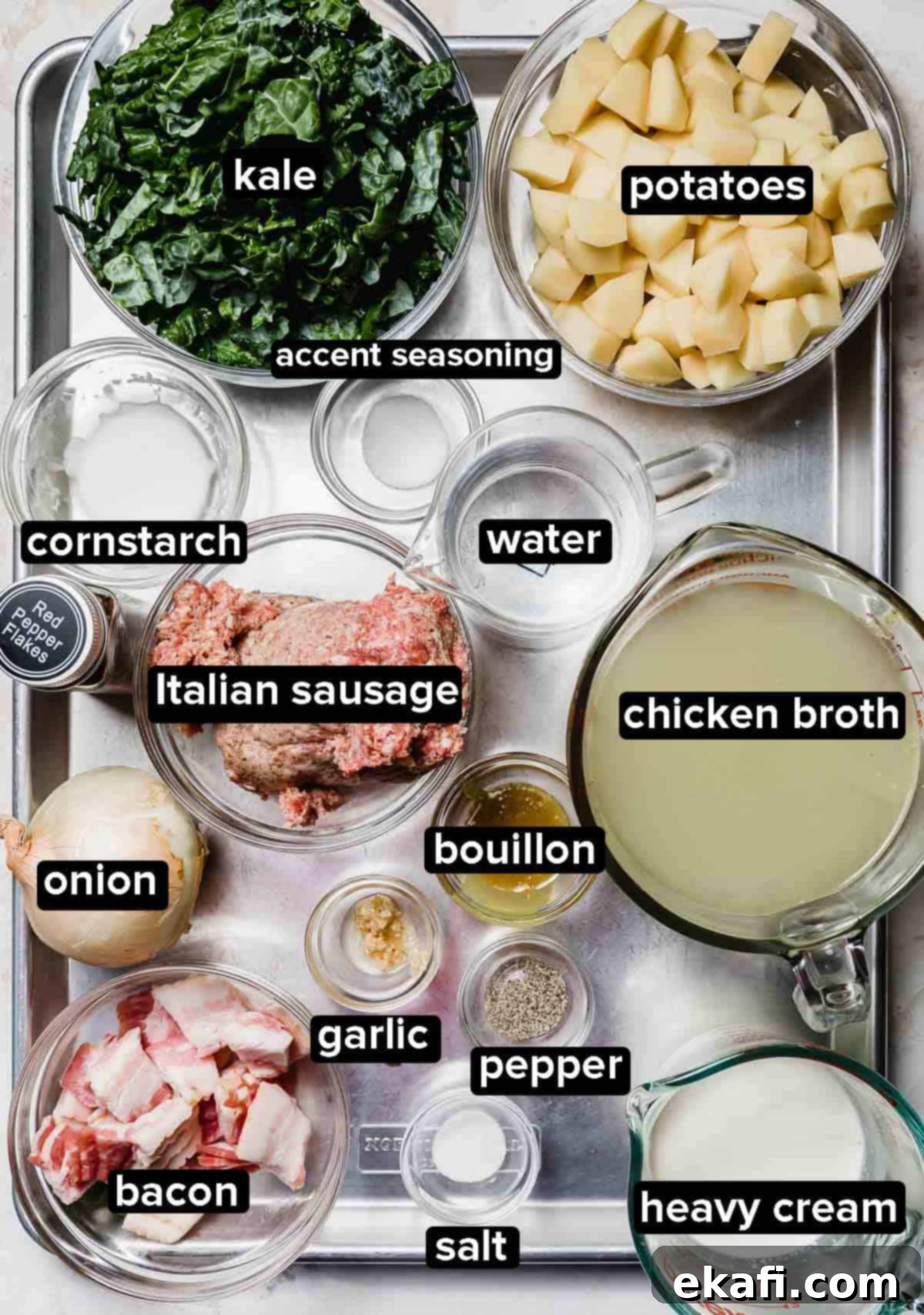 Copycat Olive Garden Zuppa Toscana 3 Olive Garden Zuppa Toscana Soup ingredients portioned into glass bowls on a silver baking sheet.