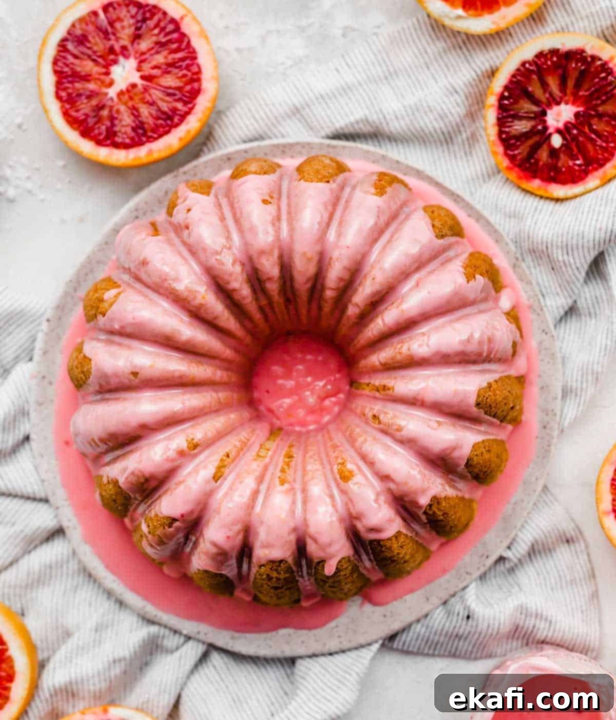 Vibrant Blood Orange Bundt Cake 2 Overhead photo of a pink blood orange glaze on a bundt cake, showcasing its vibrant color and moist texture.