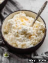 Acini di Pepe Salad 7 Acini di Pepe Salad (frog eye salad with marshmallows, cool whip, pineapple, and mandarin oranges) in a black bowl.