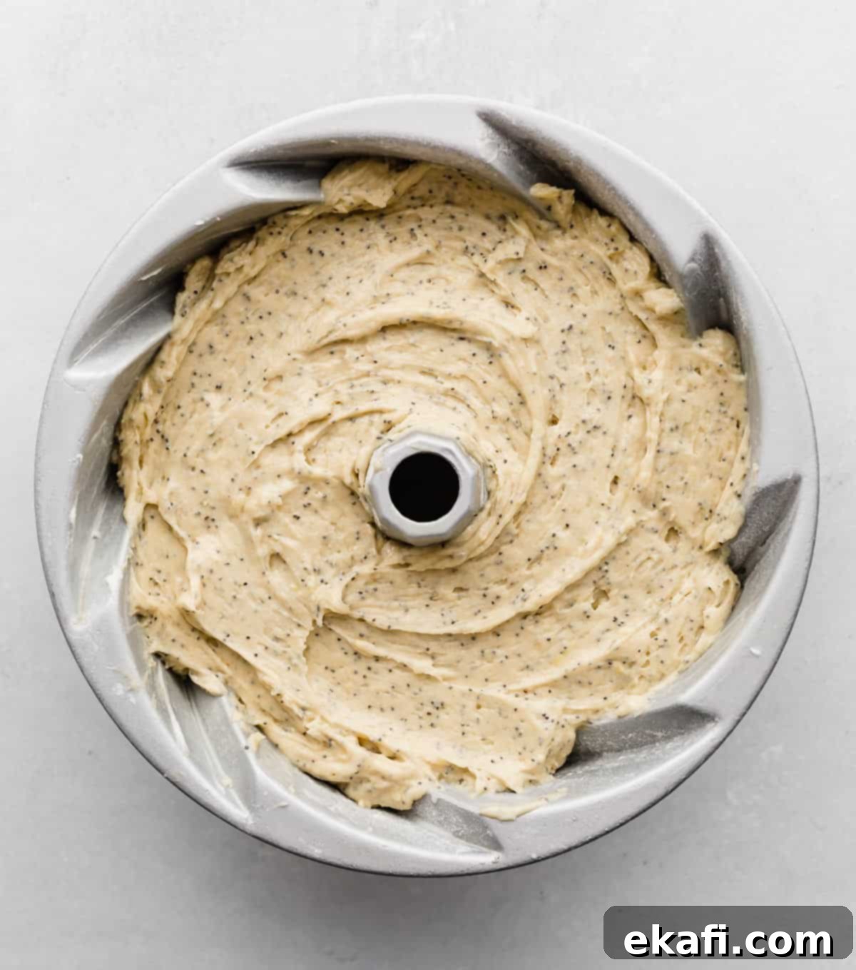 Zesty Lemon Poppy Seed Crown 4 A Bundt Cake full of lemon poppy seed cake batter.