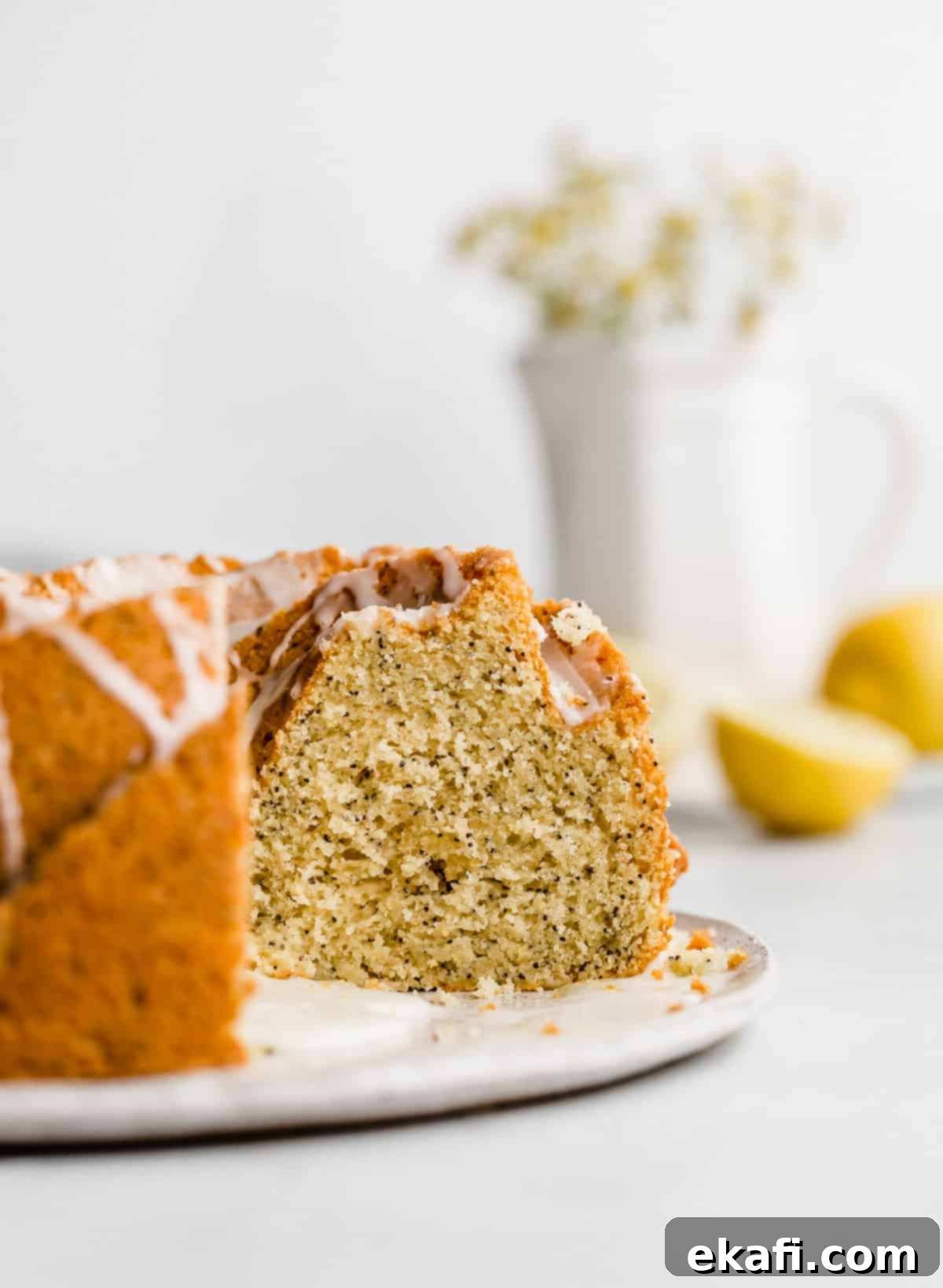 Zesty Lemon Poppy Seed Crown 8 A Lemon Poppy Seed Bundt Cake against a white background.