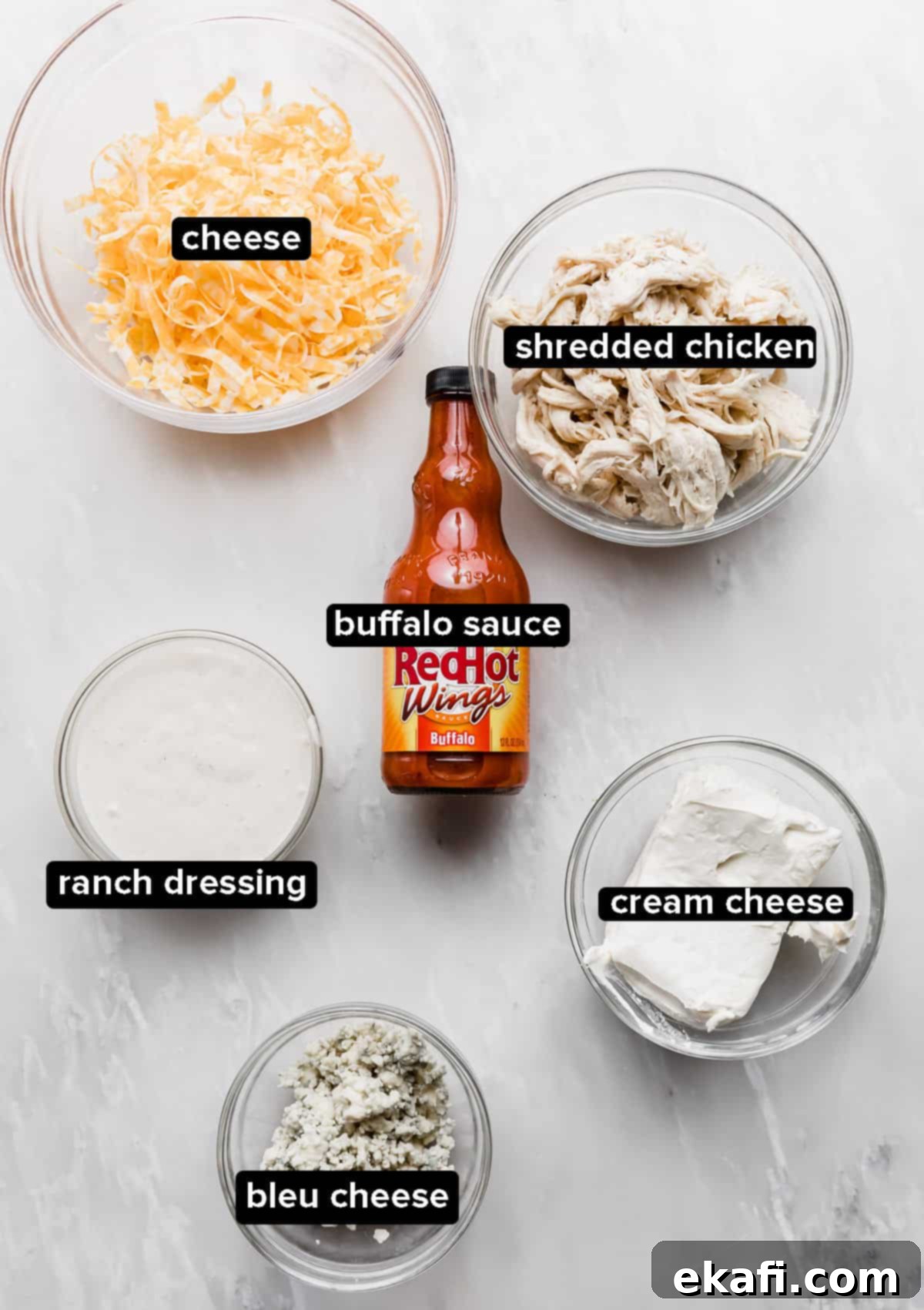 Ultimate Buffalo Chicken Dip 3 Buffalo Chicken Dip with blue cheese ingredients on a marble table.