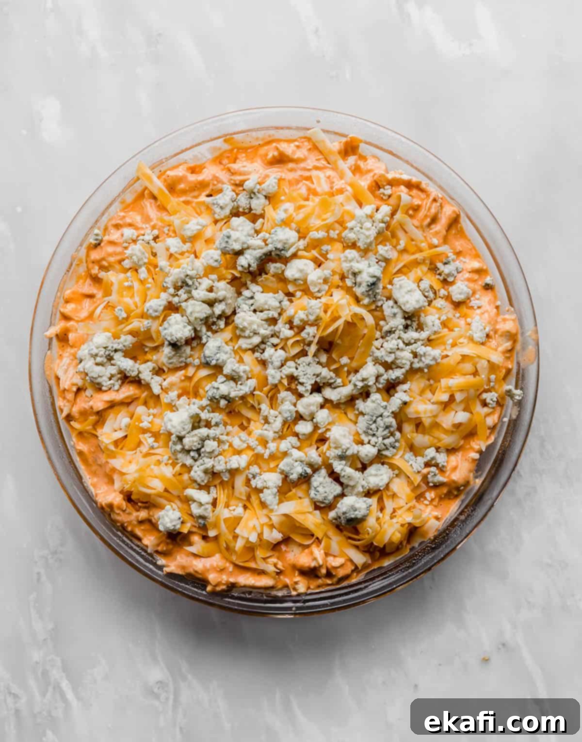 Ultimate Buffalo Chicken Dip 7 Buffalo Chicken Dip topped with blue cheese in a round dish.