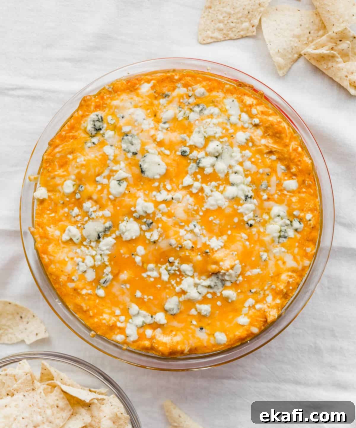 Ultimate Buffalo Chicken Dip 8 Buffalo Chicken Dip with Blue Cheese on a white napkin surrounded by flour tortilla chips.