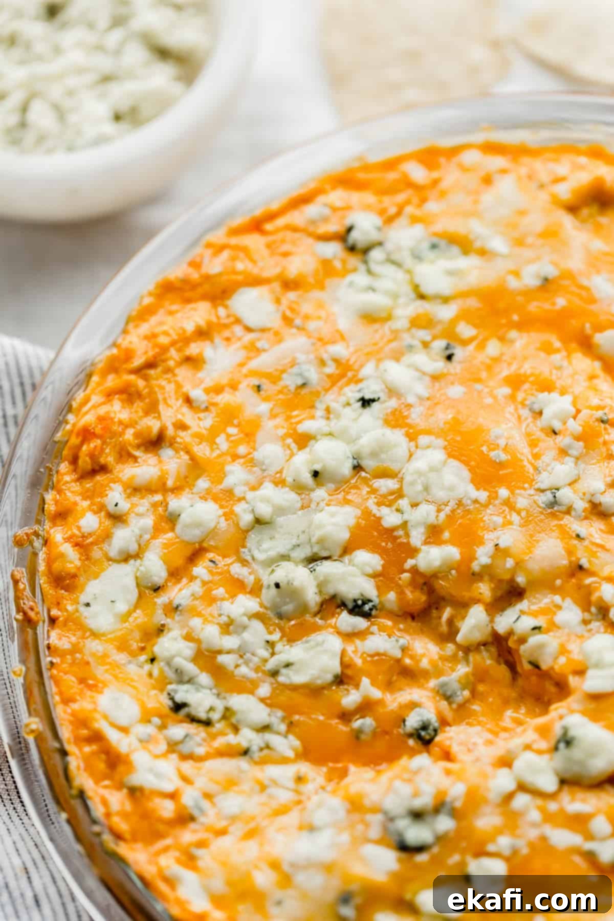 Ultimate Buffalo Chicken Dip 9 Buffalo Chicken Dip topped with Blue Cheese in a round pie plate.