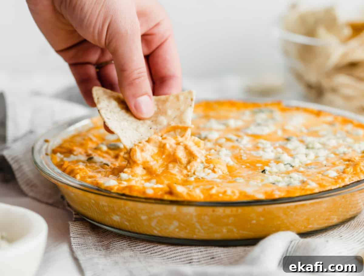 Ultimate Buffalo Chicken Dip 10 A tortilla dipping into the best buffalo chicken dip topped with bleu cheese.
