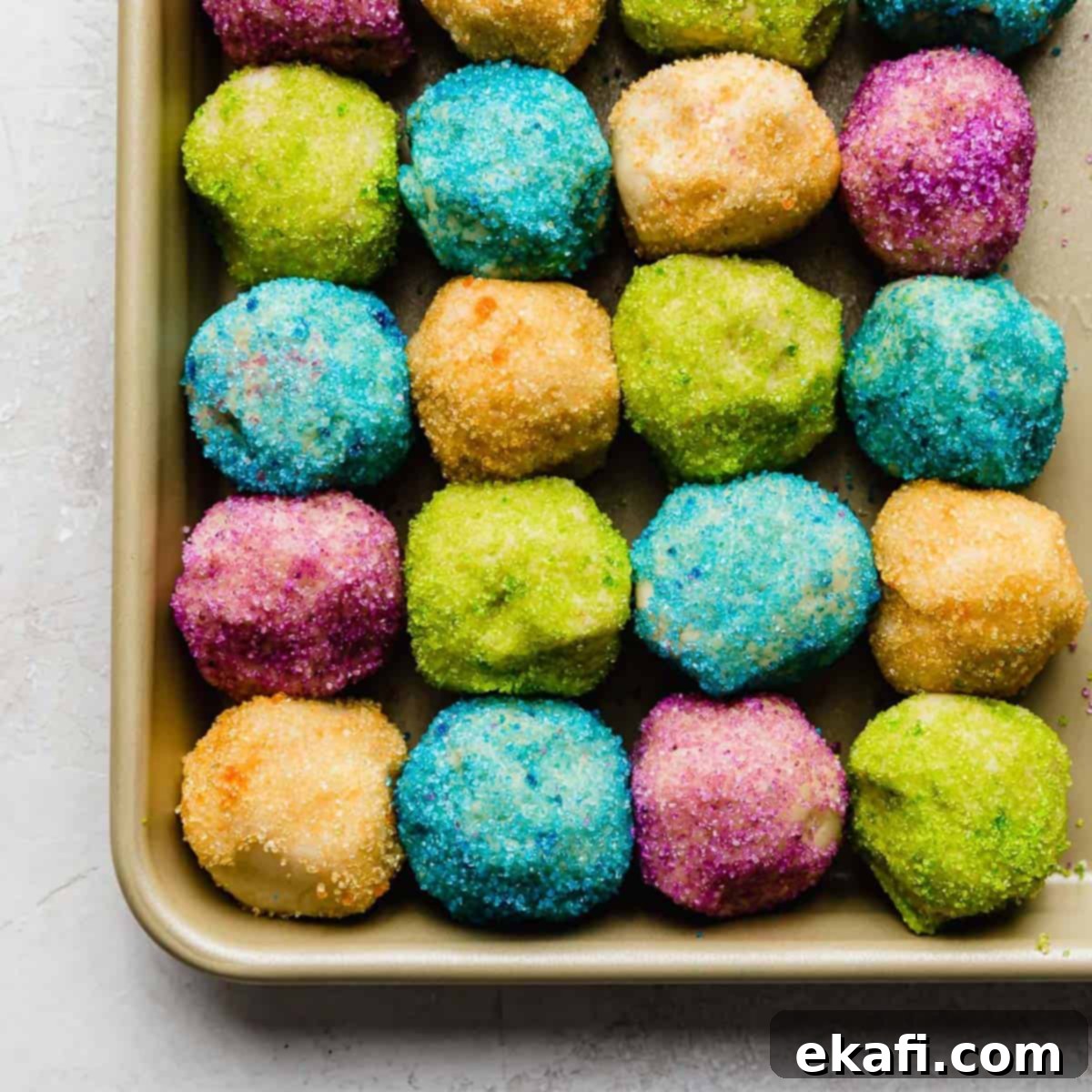 Sugared Delights 5 Sugar cookie dough balls generously coated in colorful sugar, ready for baking.