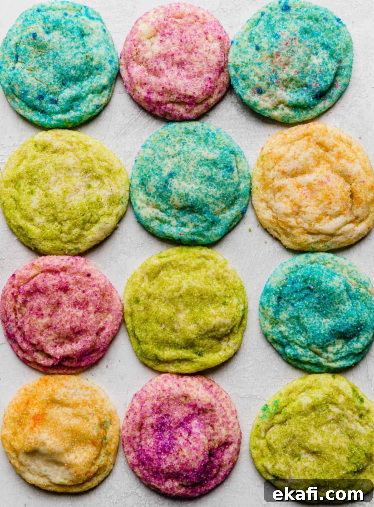 Sugared Delights 8 Baked sugar cookies beautifully covered in vibrant colorful sugar, presented on a clean white background.