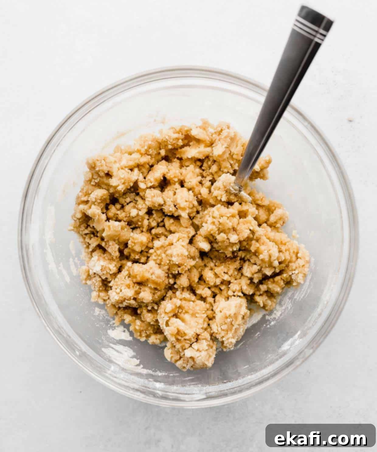 Ultra Moist Lemon Poppy Seed Muffins with Sour Cream 4 A perfectly crumbly brown sugar streusel topping in a clear glass bowl, resting on a clean white background, ready to be sprinkled.