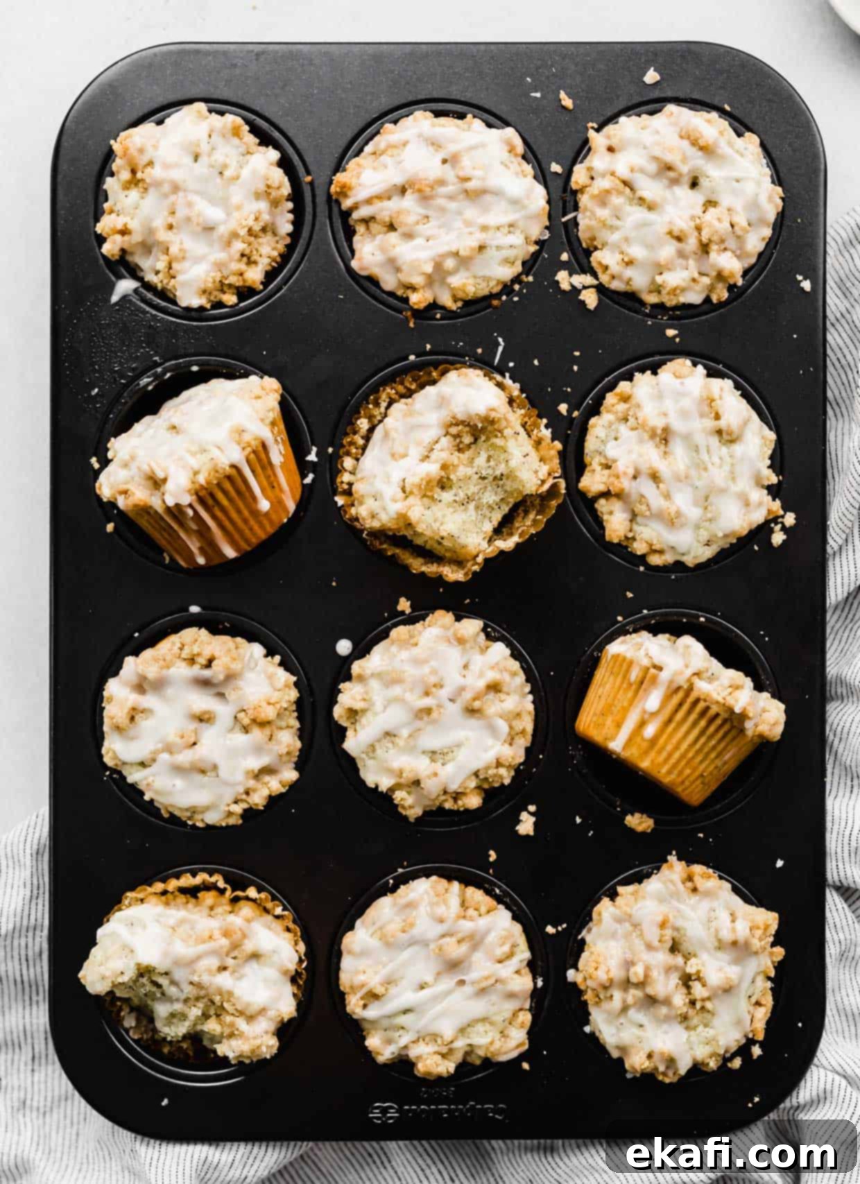 Ultra Moist Lemon Poppy Seed Muffins with Sour Cream 8 A muffin tin filled with freshly baked Lemon Poppy Seed Muffins, beautifully topped with a golden brown crumb and a delicate lemon glaze.