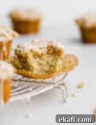 Ultra Moist Lemon Poppy Seed Muffins with Sour Cream 10 A delicious Lemon Poppy Seed Muffin, showing its crumb topping and moist interior, ready to be enjoyed.