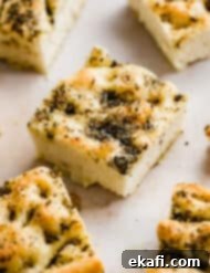 Artisanal Focaccia Bread 12 Herb topped fluffy Focaccia Bread cut into squares.