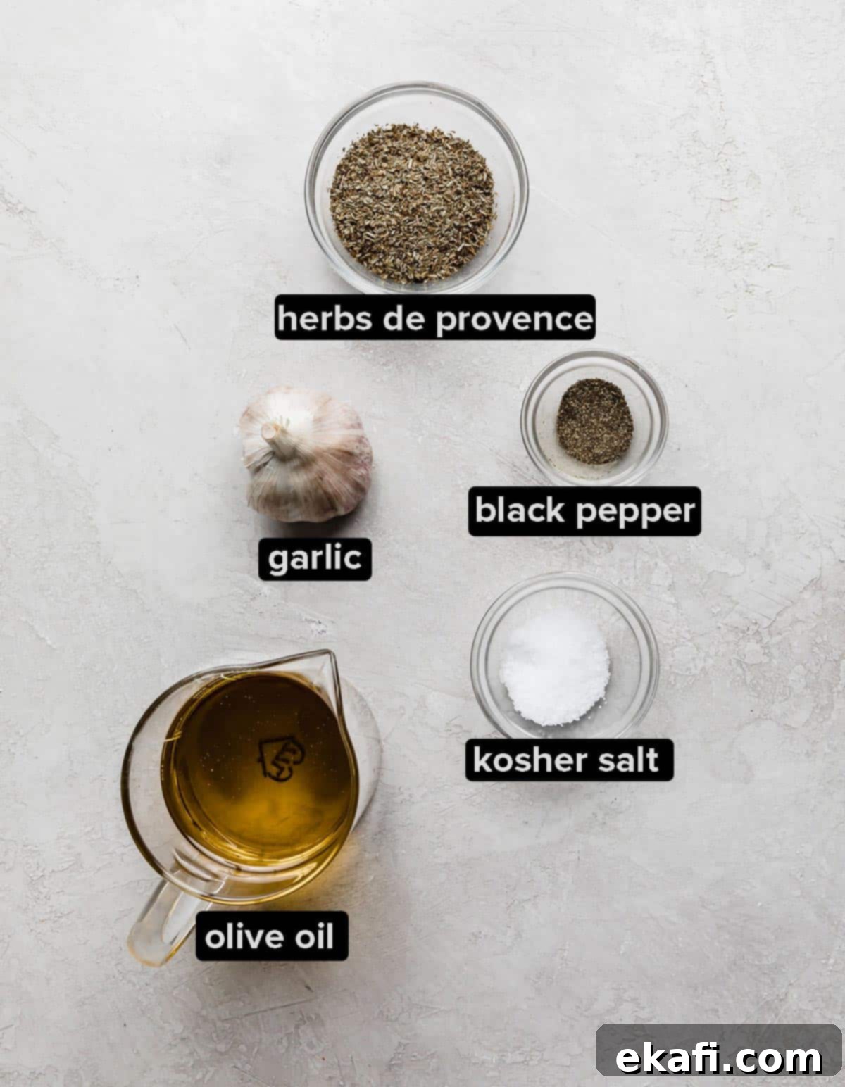 Artisanal Focaccia Bread 3 Focaccia Bread herb oil ingredients in small glass bowls on a white textured background.