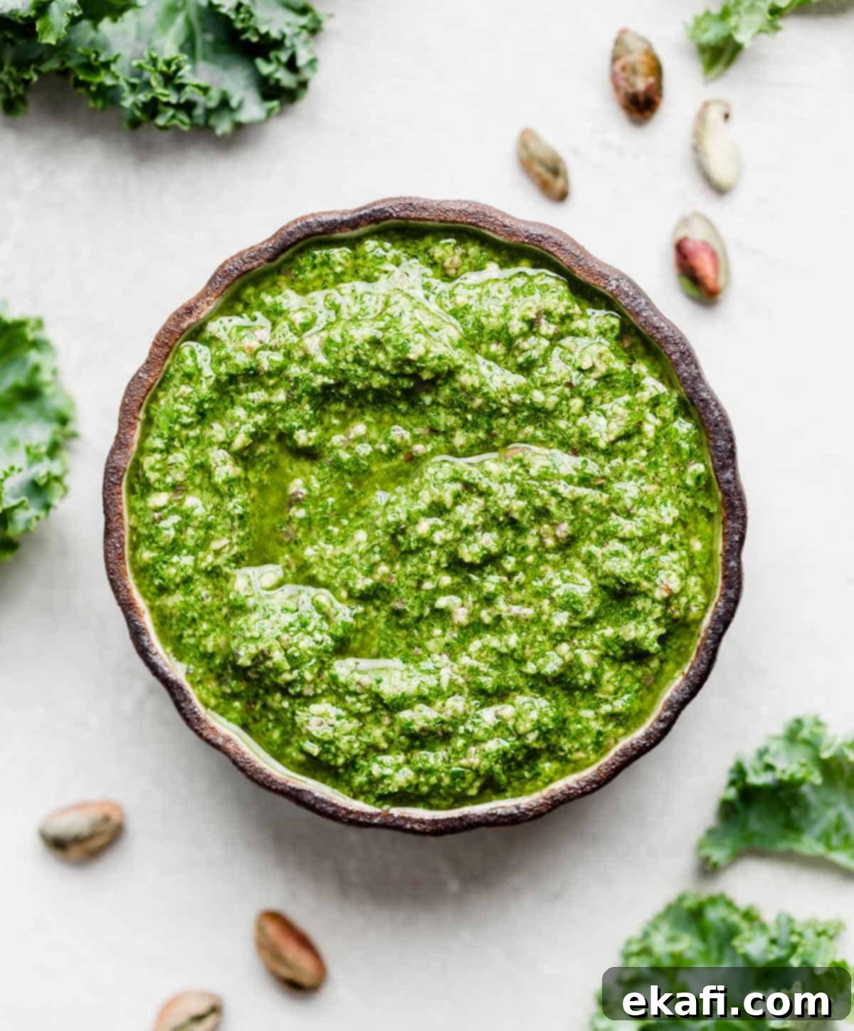 Easy Kale Pesto 6 A black bowl filled with bright green kale pesto, ready to be served.