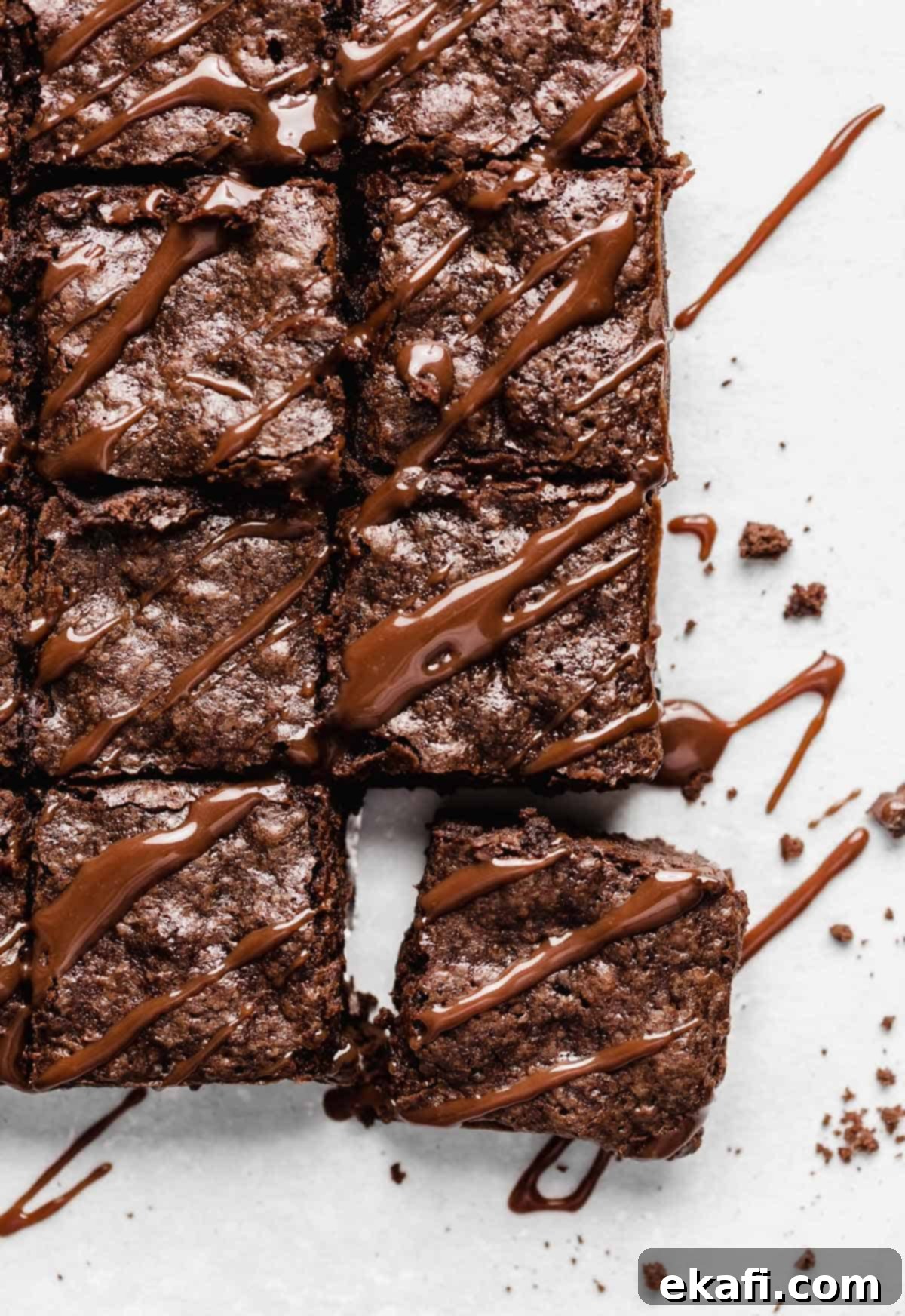 Fudgy Homemade Brownies 6 Homemade Brownies cut into small squares with hot fudge drizzled overtop.