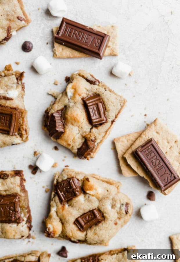 Smores Cookies 3 An overhead shot of a single s'mores cookie, showing the melted Hershey's chocolate pieces on top of the golden-brown, marshmallow-filled cookie base.