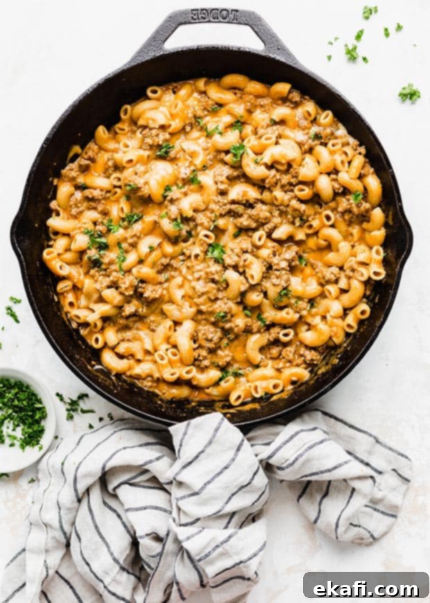 Homemade Cheesy Beef Pasta Skillet 9 Overhead photo of a black skillet full of a cheesy macaroni and meat pasta.
