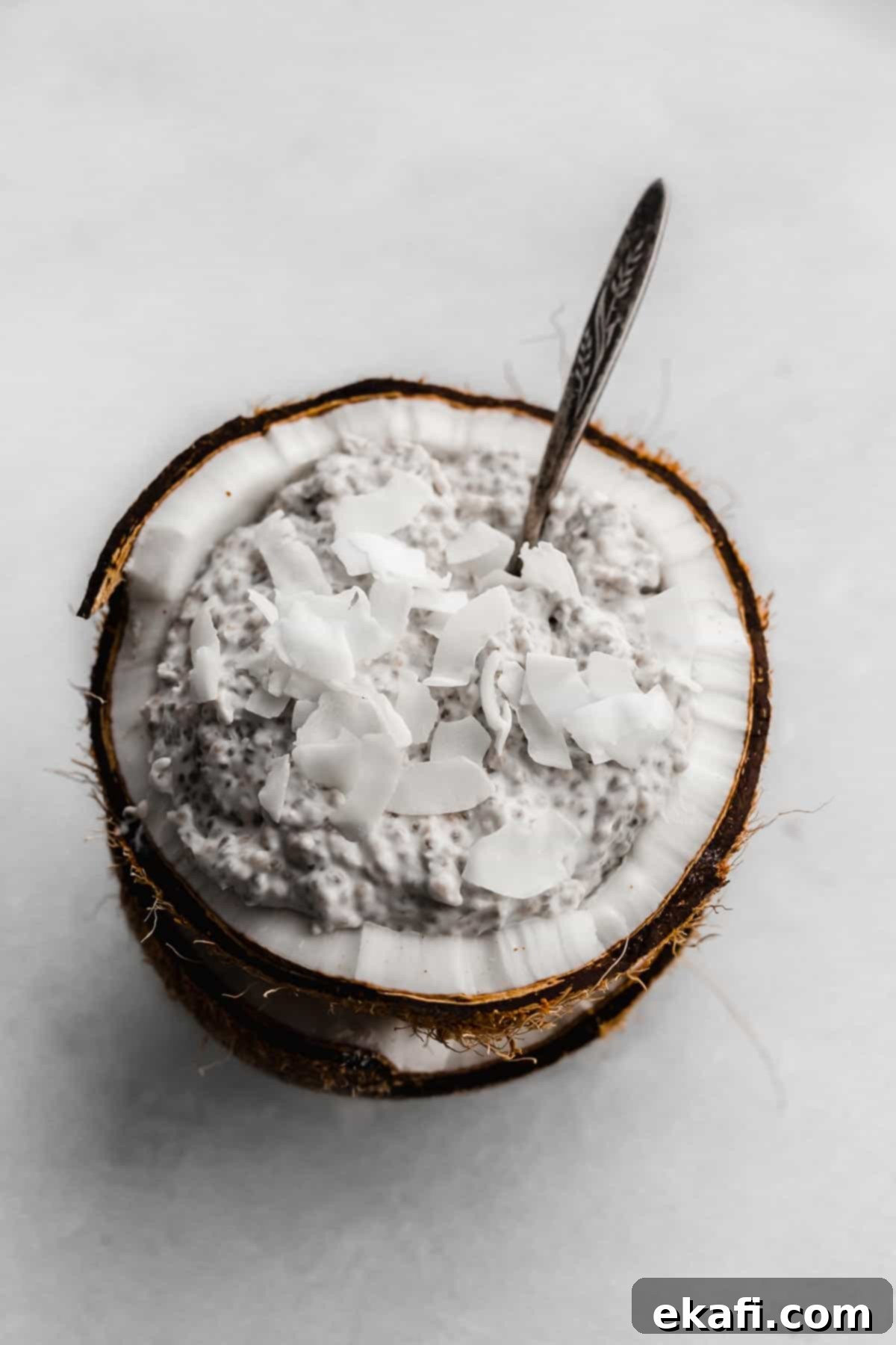 Tropical Chia Pudding Bliss 5 Overnight Coconut Chia Pudding topped with flaky coconut on a white background.