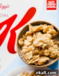 Special K Crunch Bites 10 A bowl of Special K Cereal Candy sitting on top of a box of Special K Cereal.