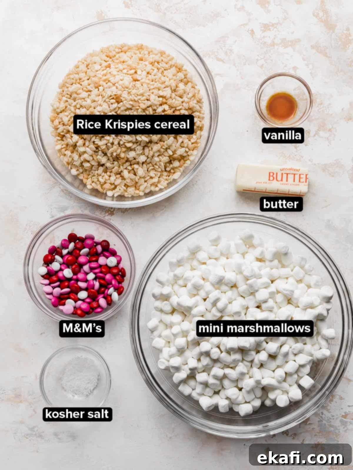 Colorful M and M Rice Krispie Bars 3 Valentine Rice Krispie Treats ingredients in a glass bowl on a white background.
