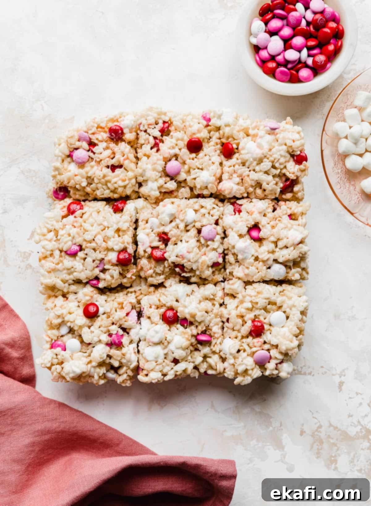 Colorful M and M Rice Krispie Bars 7 Valentine Rice Krispie Treats cut into 9 squares on a white background.