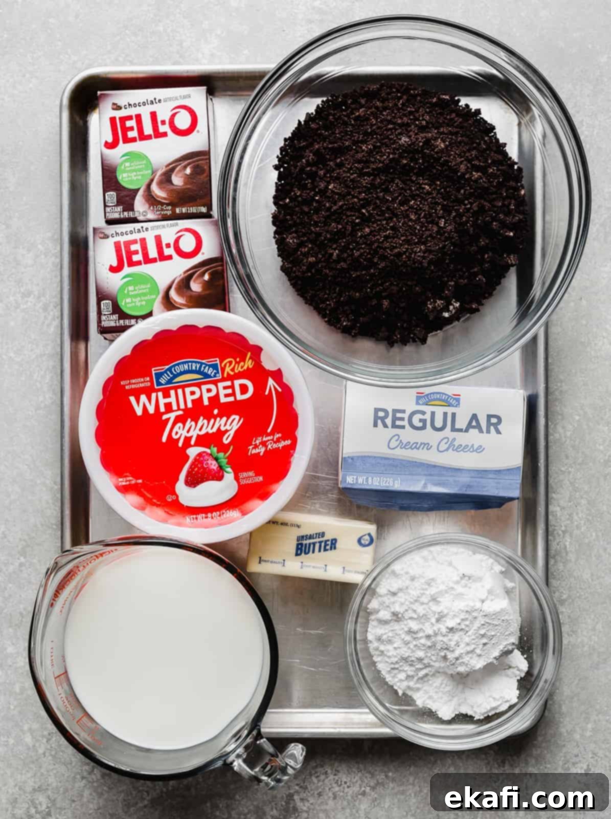 Effortless Oreo Magic 4 A baking tray full of ingredients needed to make an Oreo layer dessert.