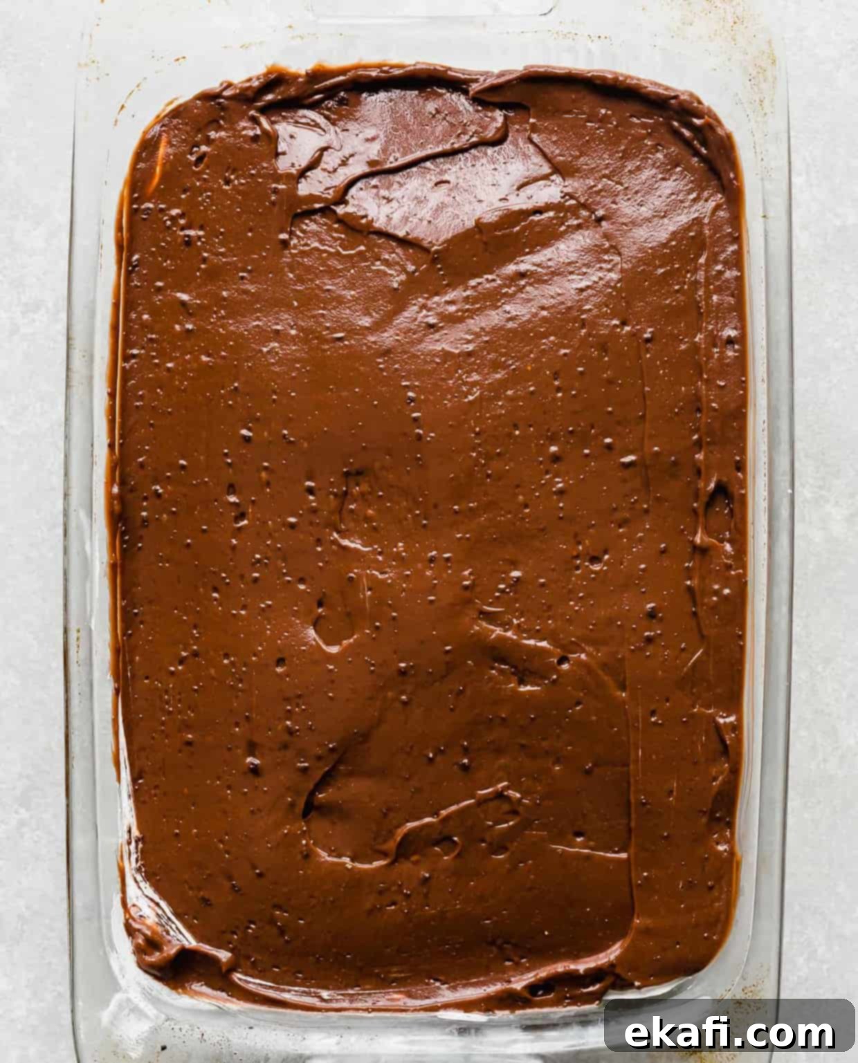 Effortless Oreo Magic 7 Chocolate pudding in an even layer in a casserole dish.