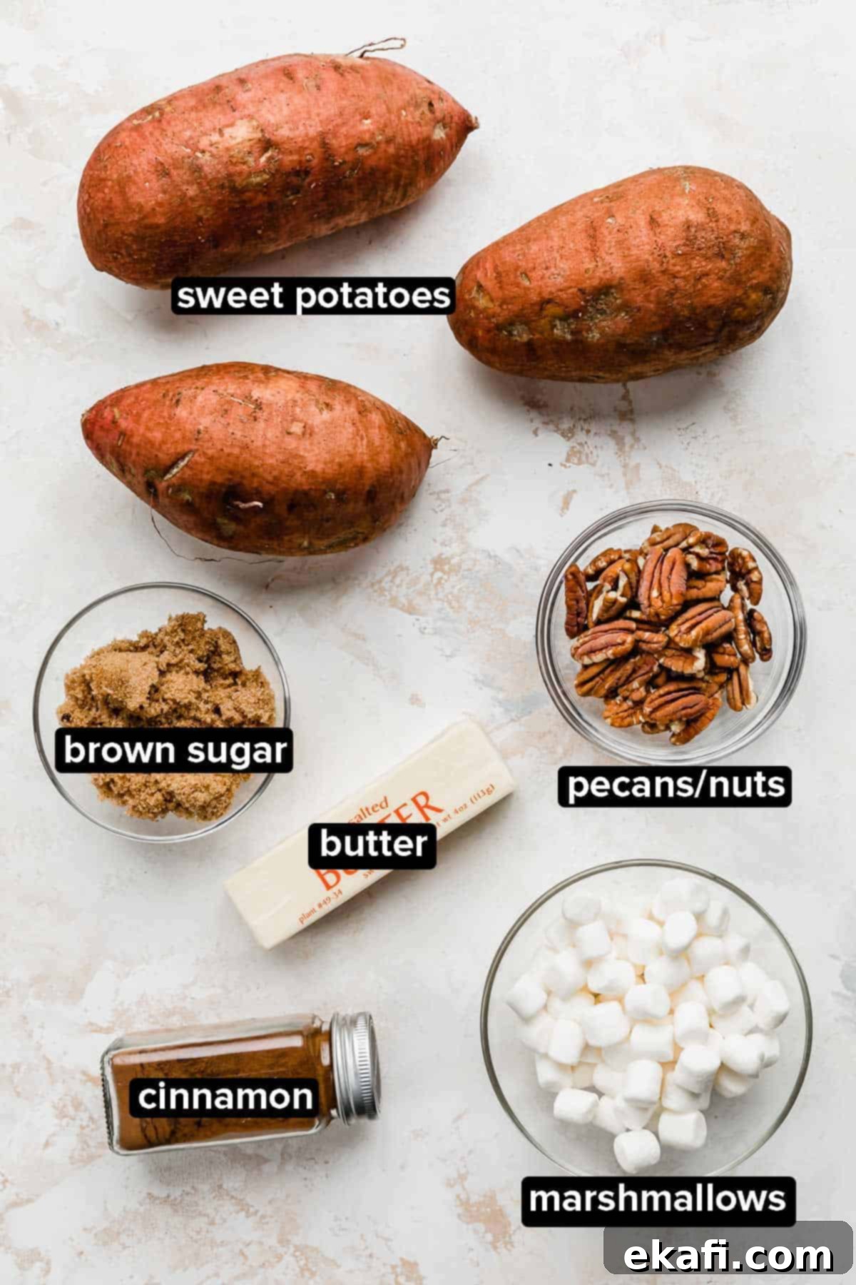 Easy Baked Sweet Potato 3 Baked Sweet Potato ingredients and sweet potato topping ideas on a white background: marshmallows, cinnamon, butter, nuts, brown sugar.
