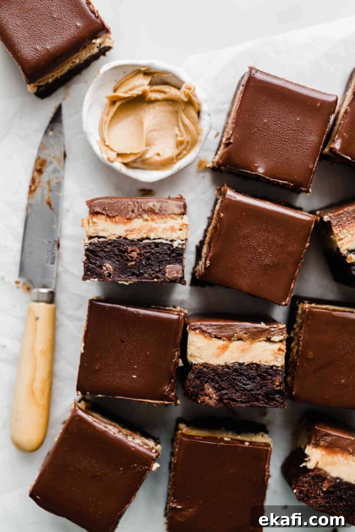 Ultimate Buckeye Brownies 8 Buckeye Brownies cut into squares, arranged neatly on a white background.