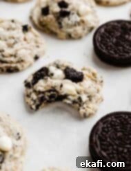Cookies and Cream Cookies 7 A bite taken out of a Cookies and Cream Cookies, that's on a white parchment paper.
